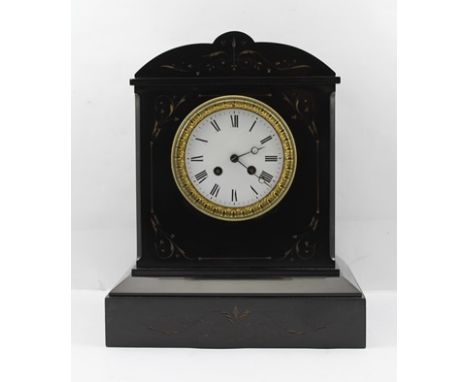A VICTORIAN BLACK SLATE CASED MANTEL CLOCK with carved decoration, gilded, with white enamel dial bearing Roman numerals with