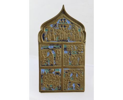 A RUSSIAN PORTABLE ICON in cast brass with enamel detail depicts Jesus' life, verso Golgotha, with brass stand, 16cm high 