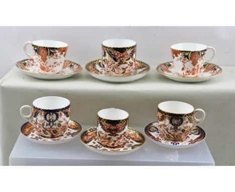 SIX ROYAL CROWN DERBY CUPS AND SAUCERS decorated in the Imari pattern (variations on patterns and shapes)