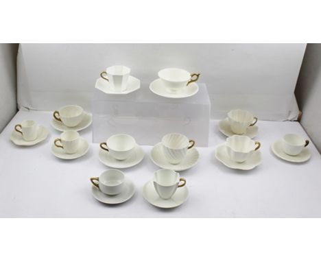  A COLLECTION OF TWELVE ASSORTED WHITE CERAMIC TEA AND COFFEE CUPS WITH SAUCERS, all the cups have gilded handles, factories 