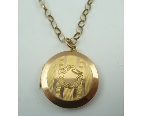A LOCKET with engine turned decoration, on a 9CT. BELCHER CHAIN 