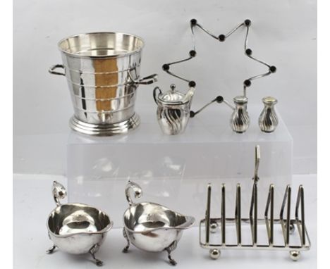 A DANISH SILVER PLATED TAPER STICK HOLDER of star form, together with a silver plated ICE BUCKET, a TOAST RACK and a pair of 