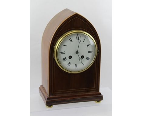 AN EDWARDIAN MAHOGANY CASED LANCET FORM MANTEL CLOCK, the white enamel dial with Roman numerals, eight day chiming movement, 
