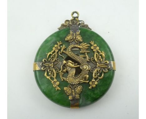 A CHINESE GREEN HARDSTONE "BI" DISC PENDANT, most probably jade, of a bright green colour with "mutton fat" suffusions. Based