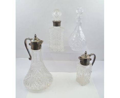 AN EPNS MOUNTED CUT GLASS CLARET JUG with mask spout and scroll handle, 30cm A MATCHING SPIRIT DECANTER with mask spout and s