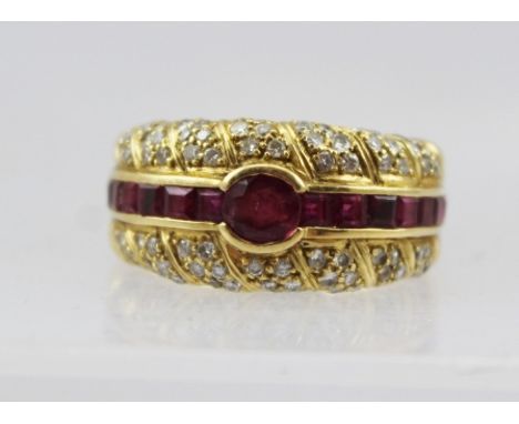 AN 18CT GOLD CONTEMPORARY DESIGN DRESS RING set with a band of rubies, flanked by bands of small diamonds, size Q 1/2, overal