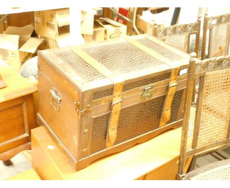 A leather finished trunk, with wooden carcass and leather straps.