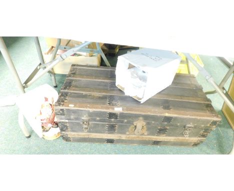 A metal bound trunk, and a Christmas ornament of Father Christmas playing the bagpipes. 