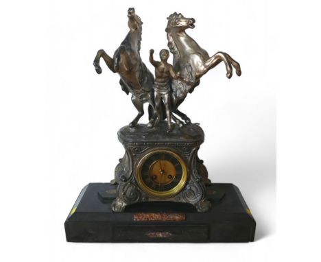 A late Victorian spelter mantel clock, with a black marble base surmounted by Marly type horse group, 44 by 17 by 52cm high.