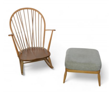 An Ercol beech stick back rocking chair, together with an upholstered footstool. (2)Split to the seat of the rocking chair.