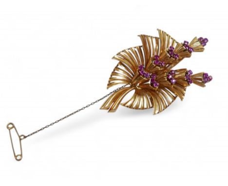 A yellow metal and ruby floral spray brooch, each ruby approximately 2mm diameter, with rubbed hallmarks, 16.2g, 3.6 by 6cm.