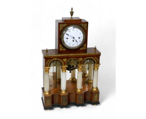 A 19th century continental mantel clock, its Roman numeral dial, with marble effect column supports, gilt metal mounts, 39 by