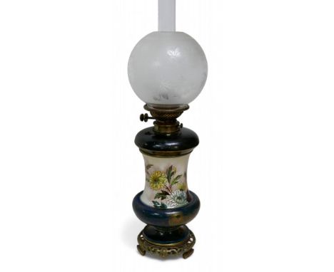A Victorian Doulton oil lamp with Mary Capes design, maker's marks to ceramic bases, with gilt metal fittings, later chimney 