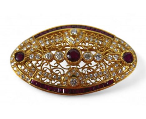 An 18ct gold diamond and ruby oval form brooch, with round cut diamonds and rubies central round cut ruby approximately, 4mm 