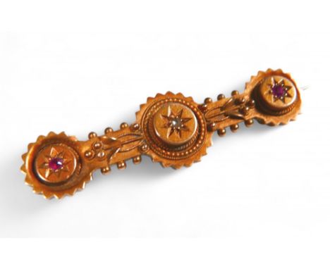 A 15ct gold diamond and ruby bar brooch, small stones approximately 1mm diameter, with white metal pin, 3.6g gross, 4.3cm wid