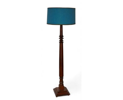 An early 20th century mahogany standard lamp, with blue shade and turned support, 177cm high.
