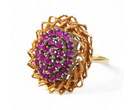 An 18ct gold ruby and diamond cluster ring, each ruby approximately 1mm diameter, a/f, 6.4g.Bent band.