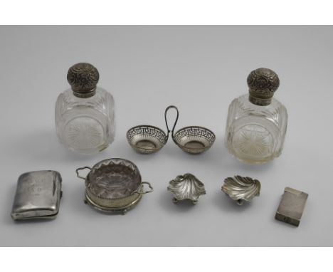 TWO SIMILAR LATE VICTORIAN MOUNTED CUT-GLASS TOILET BOTTLES with embossed globular hinged covers and glass stoppers, initiall