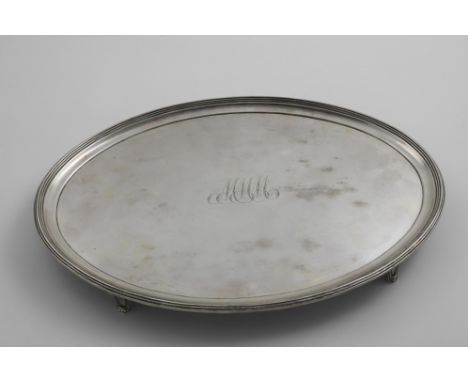 A GEORGE III OVAL SALVER with a reeded border and four reed-bordered bracket feet, engraved in the centre with the scrip init