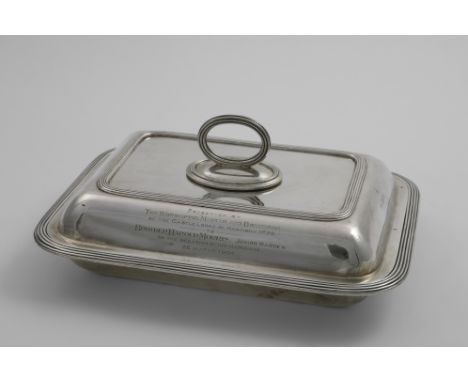 AN EDWARDIAN OBLONG ENTREE DISH AND COVER with rounded corners, reeded borders and a detachable ring handle, engraved on the 