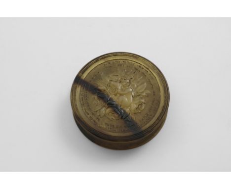 AN EARLY 19TH CENTURY PRESSED HORN CIRCULAR SNUFF BOX translucent and blond in colour, with a putto, roses, a bee and lines o