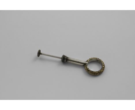 A RARE AND AMUSING GEORGE IV / WILLIAM IV NOVELTY FINGER RING the band gold-cased and chased with flowers, hiding a tiny pin 