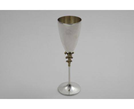 BY STUART DEVLIN:- A late 20th century parcel-gilt commemorative champagne goblet with the Prince of Wales's feathers incorpo