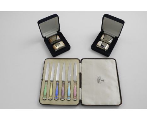 AN EARLY 20TH CENTURY CASED SET OF SIX TEA KNIVES with stainless steel blades and silvergilt and coloured enamel handles with