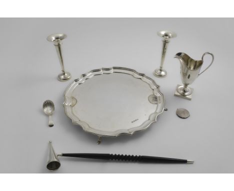 A MIXED LOT:- A 20th century salver of shaped circular outline with a moulded border and four feet, a pedestal cream jug, a G