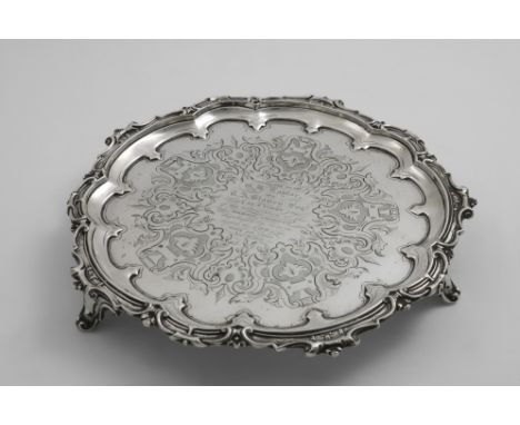 LIFE SAVING:- A Victorian engraved salver of shaped circular outline with a formal scroll border, the centre inscribed "Prese