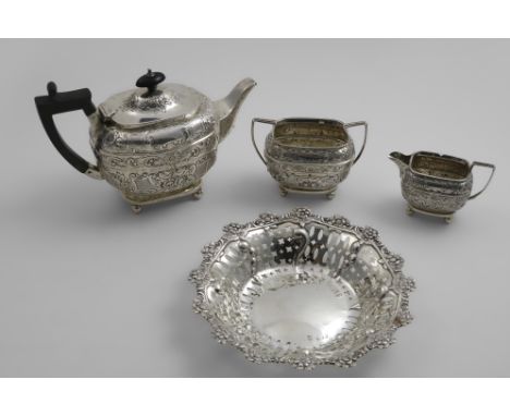 A LATE VICTORIAN SMALL THREE-PIECE TEA SET with embossed decoration, angular handles &amp; ball feet, by Charles Stuart Harri