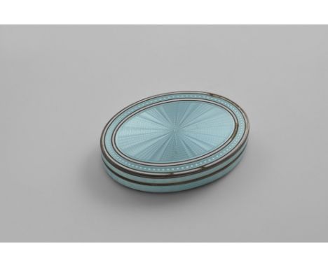 A CONTINENTAL OVAL BOX AND COVER decorated in translucent pale blue enamel over an engine-turned ground, with white linen bor