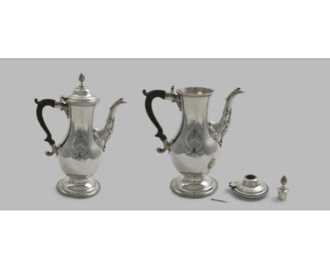 A GEORGE III BALUSTER CHOCOLATE POT on a spreading circular foot with a leaf-wrapped spout, a detachable domed cover and a re