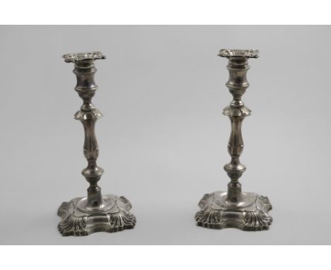 A PAIR OF LATE VICTORIAN CANDLESTICKS on shaped square bases with knopped and shouldered columns and shell decoration, detach