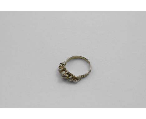 A 16TH CENTURY ( TUDOR) SILVERGILT RING in the form of a heart, scratched "I.H.S" and flanked by two lion supporters, the ban