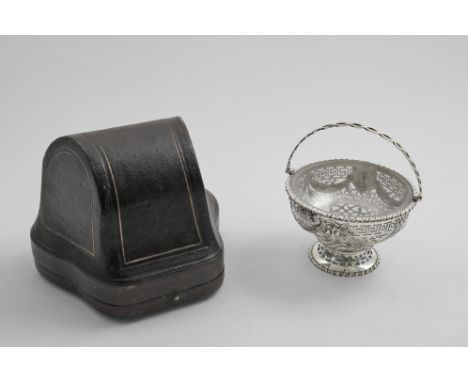 A VICTORIAN SWING HANDLED SUGAR BASKET with piercing and embossed drapery festoons around the sides &amp; two greenman masks,