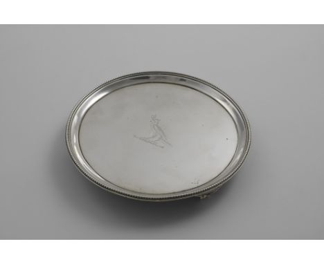 A GEORGE III SMALL CIRCULAR SALVER with bead borders and bracket feet, crested, by T. Hannam and J. Crouch, London 1786;  7.1