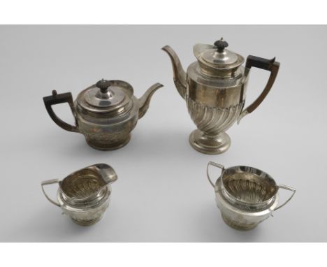 A LATE VICTORIAN MATCHED FOUR-PIECE TEA &amp; COFFEE SERVICE Vase-shaped with embossed wrythen fluting around the lower bodie