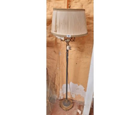 An ornate brass and painted metal three branch standard lamp with remains of original shade