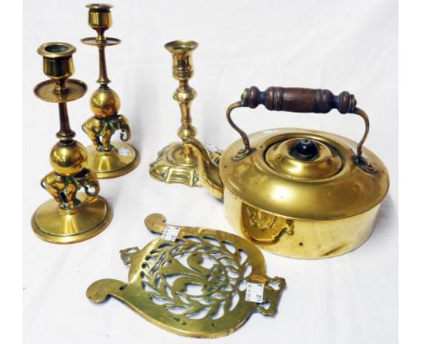 A selection of brass items comprising kettle, a pair of elephant stem candlesticks, 18th Century candlestick, and a trivet