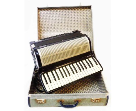 A hard cased Frisco piano accordion
