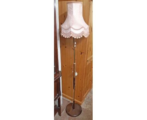 A mid 20th Century retro brassed metal and teak standard lamp