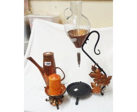 A wrought iron and copper wine carafe with glass vessel, a hammered copper coffee pot, and a Gothic style wrought iron and co