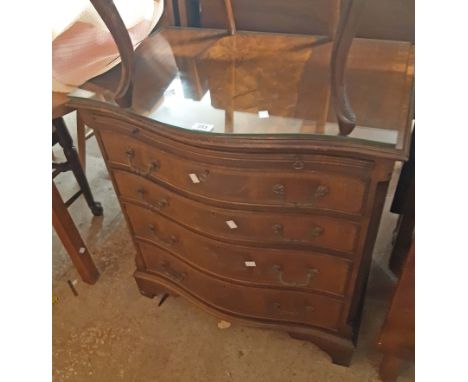 A 71cm reproduction mahogany and cross banded serpentine front bachelor's chest with brushing slide and four long graduated d