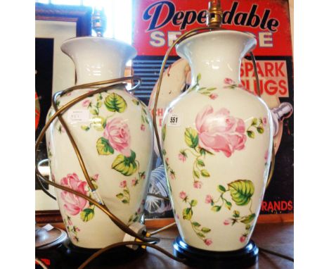 A pair of ceramic baluster vase lamps decorated with transfer printed roses - one a/f