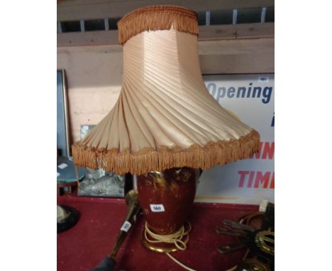 A ceramic temple jar form table lamp with gilt dragon on red ground - with shade