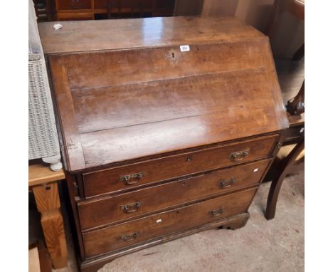 A 95cm late Georgian oak bureau, the fitted interior with three banks of four drawers over three long graduated drawers, set 