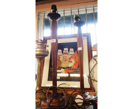 A pair of slender reeded wooden lamps of candlestick form