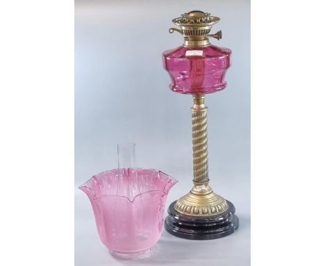 Early 20th century double oil burner lamp having clear and frosted etched cranberry glass foliate shade above a cranberry gla