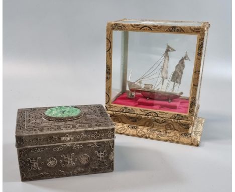 White metal model of a sailing Junk mounded in a rectangular glass box on stand together with a white metal lidded box decora